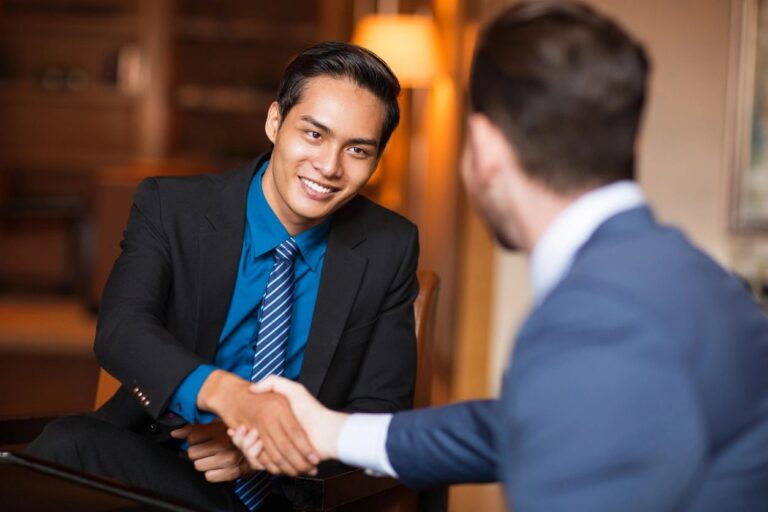 Two people shaking hands over a business agreement